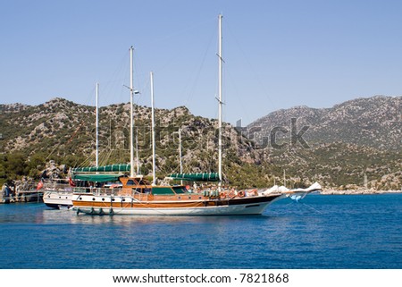 Yachts; sailing vessels; boats; masts; blue; the sea; ocean; island; stones; coast; rest; travel
