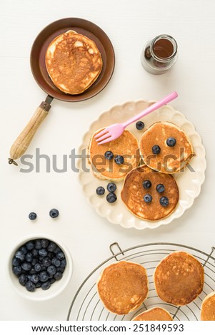 Pancakes with blueberries and a small pan