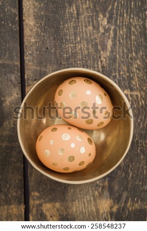 Eggs with golden dots in a golden bowl