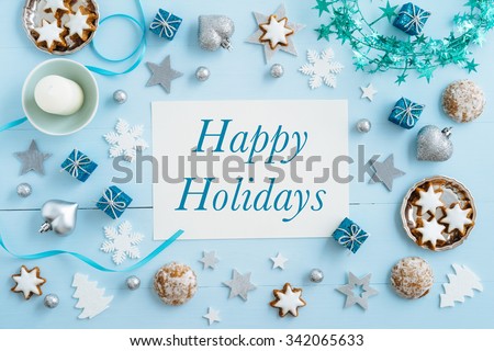 Christmas background, mockup, postcard or website header design with the words Happy Holidays on blue wooden table