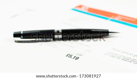 Bill to pay with black pen in the background