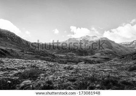 Black and White of Y Garn with sun rays shinning across it's snowy face