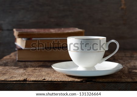 White circle on a wooden table with books