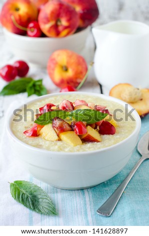 Milk porridge with peaches and cherries