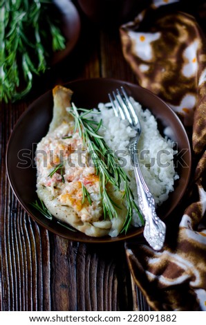 Baked sea bass with tomatoes, feta cheese, rosemary and garnished with rice
