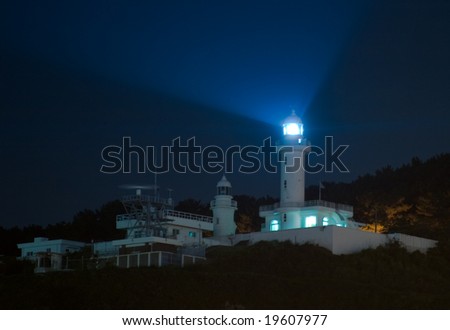 Light rays at night from a lighthouse