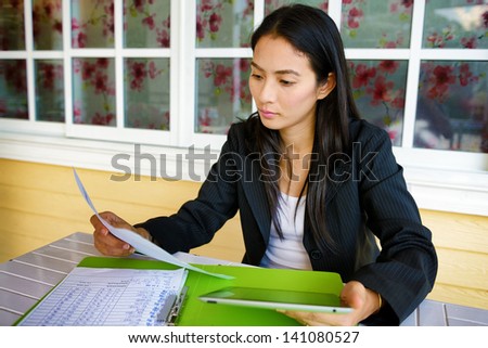 Business woman working with electronic tablet in restaurant