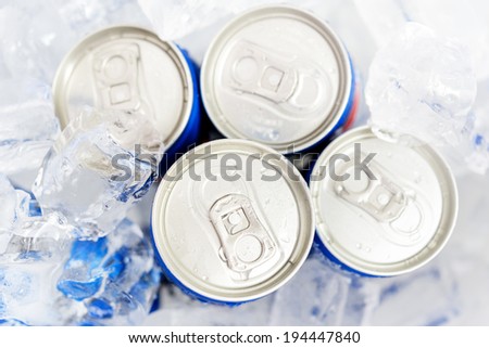Soda cans in ice with condensation - drink can
