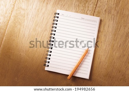 Blank spiral notebook with line paper  on wood table