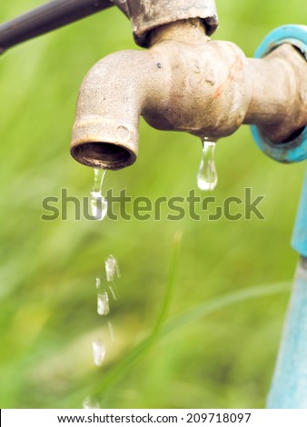Wasting water - water drop from water tap
