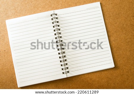 Blank spiral notebook with line paper on wood table
