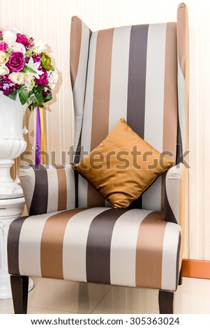 Luxurious armchair with artificial flower