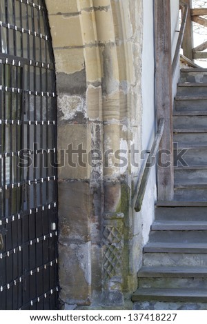 Part of the wrought-iron gate and wooden stairs in the old castle.