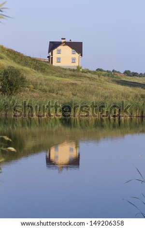 New house in the mirror of the lake.