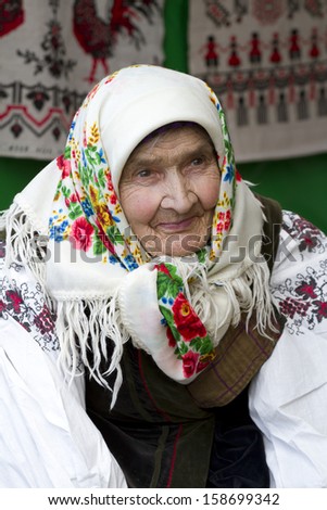 Portrait of an old woman in national dress, who has lived a hard life.