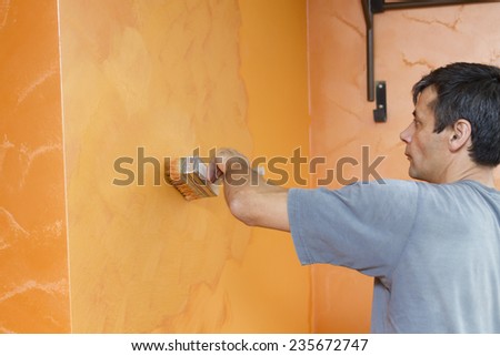 Confident professional house painter to create a pattern.