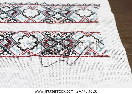 The pattern on the cloth embroidered cross.