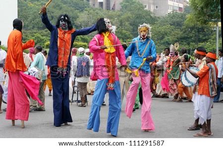 HYDERABAD,AP,INDIA-AUGUST 22:kokali-kattaiA folk dance form dancers perform during world folk art day event in ravindra bharati on August 22,2012 in Hyderabad,Ap,India.3 feet high stilt dance form.