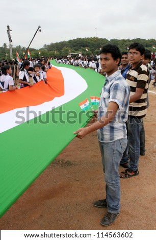 HYDERABAD,AP,INDIA-AUGUST 28:School Children assemble with long flag,  to render national anthem,to mark 100 th year of the song, in  event by NTV ar NTR ground on August 28,2012 in Hyderabad,India.