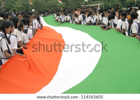 HYDERABAD,AP,INDIA-AUGUST 28:School Children assemble with long flag,  to render inational anthem,to mark 100 th year of the song, in  event by NTV ar NTR ground on August 28,2012 in Hyderabad,India.