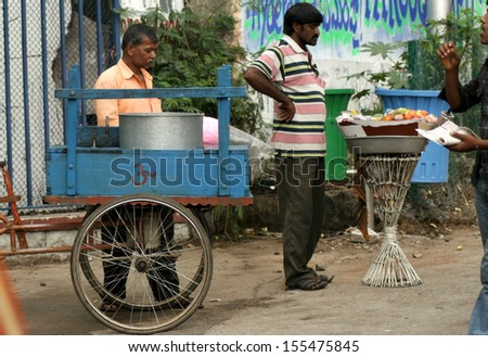 HYDERABAD,AP,INDIA-SEPTEMBER 18:People buy / eat street food on abundant  during ganesha immersion ,a festival,on September 18,2013 in hyderabad,India.Traders use mobile carts to conduct business.