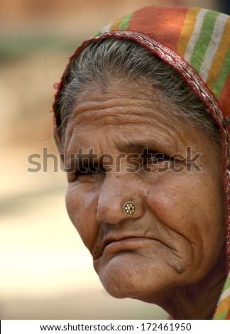 HYDERABAD,AP,INDIA-JANUARY 12:Old indian woman staring at the photographer on January 12,2014 in Hyderabad,Ap,India.