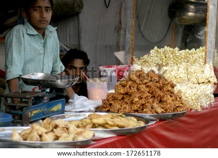HYDERABA,AP,INDIA-JANUARY 20:Indian vendor sell street food in a busy market place on January 20,2014 in Hyderabad<Ap,India.