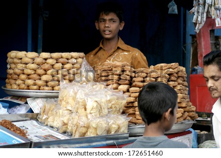 HYDERABAD,AP,INDIA-JANUARY 20:Indian vendor sell street food in a busy market place on January 20,2014 in Hyderabad,Ap,India.