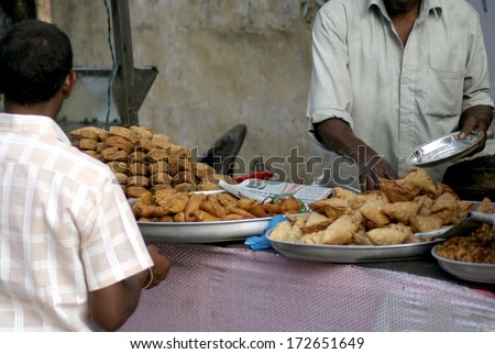 HYDERABAD,AP,INDIA-JANUARY 20:Indian vendor sell street food in a busy market place on January 20,2014 in Hyderabad,Ap,India.