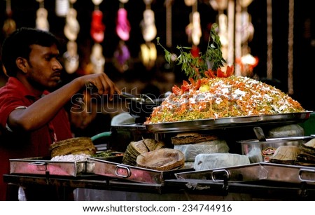 HYDERABAD,INDIA-JANUARY 12:Indian street vendor make fast food in a busy market place in Hyderabad,India on January 12,2014.
