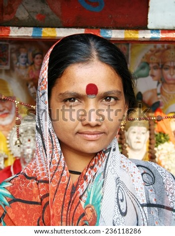 HYDERABAD,INDIA-MARCH 14:Indian woman go around with cart decorated with Hindu gods seeking help in Hyderabad,India on March 14,2012.