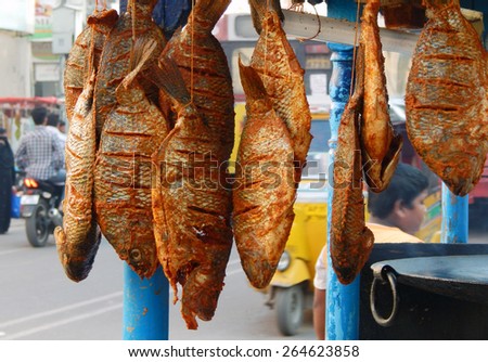 HYDERABAD,INDIA-MARCH 17:Indian street vendor sell fish fry food on a busy road on March 17,2015 in Hyderabad,India.