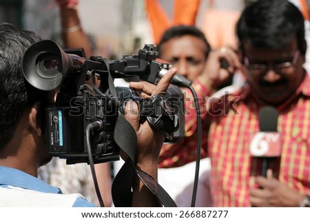 HYDERABAD,INDIA-APRIL 3:Indian TV channel videographer cover the hanuman jayanti procession,an annual event,a Hindu celebration on April 3,2015 in Hyderabad,India.