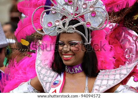 BOLOGNA, ITALY - JUN 18: Pretty Brazilian Girl masked as a Samba Dancer smiling during the \'Partòt\' Street Parade 2011 in \'Piazza Maggiore\' Bologna, Italy on Jun 18, 2011.
