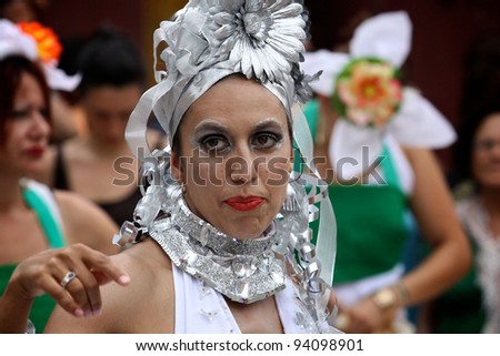 BOLOGNA, ITALY - JUN 18: Pretty Brazilian Girl masked as a Samba Dancer smiling during the \'Partòt\' Street Parade 2011 in \'Piazza Maggiore\' Bologna, Italy on Jun 18, 2011.