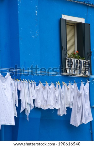 Typical house of Burano colorful with bright-blue paint.