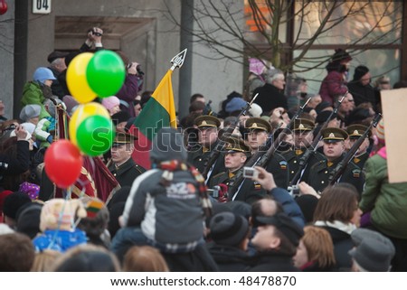 VILNIUS, LITHUANIA - MARCH 11:  People watching the ceremony of hoisting flags on 20th Anniversary of Restoration of Independence of Lithuania on Mar 11, 2010 in Vilnius, Lithuania.