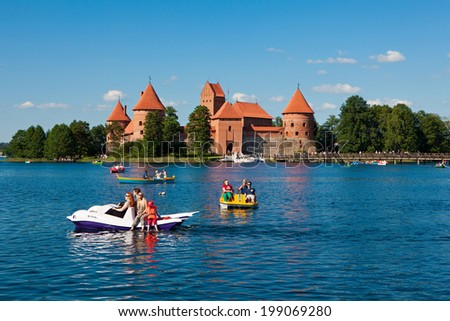 TRAKAI, LITHUANIA - JUNE 7: People boating in the lake Galve in front of Trakai Island Castle on June 7, 2014 in Trakai. Trakai Island Castle built in 14th century, now is a major tourist attraction.