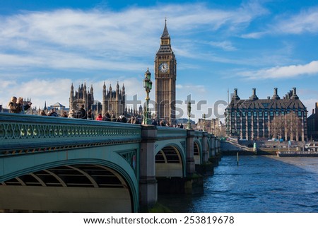 London, UK - January 30, 2015: Busy street life and traffic on Westminster bridge with Big Ben and parliament palace far behind on Jan 30, 2015 in London, UK.