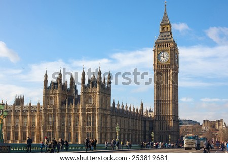 London, UK - January 30, 2015: Busy street life and traffic on Westminster bridge with Big Ben and parliament palace far behind on Jan 30, 2015 in London, UK.