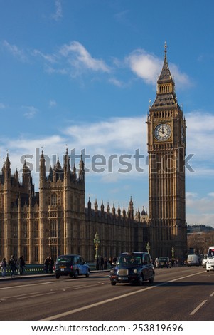 London, UK - January 30, 2015: London Taxi and Big Ben in far behind on Westminster bridge on Jan 30, 2015 in London, UK.
