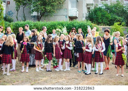 Vilnius, Lithuania - September 1, 2015: Schoolgirls and schoolboys came to the school for the first time. They watch some festive event on September 1, 2015 in Vilnius, Lithuania.