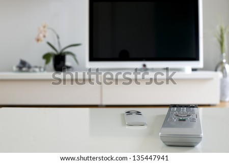 two remotes on white table for home cinema and entertainment