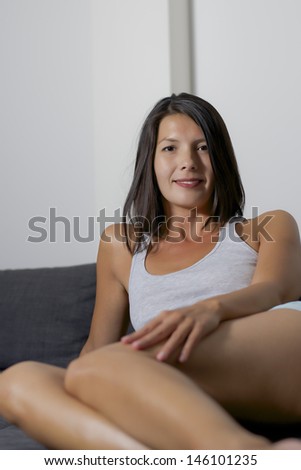 woman lays down on couch