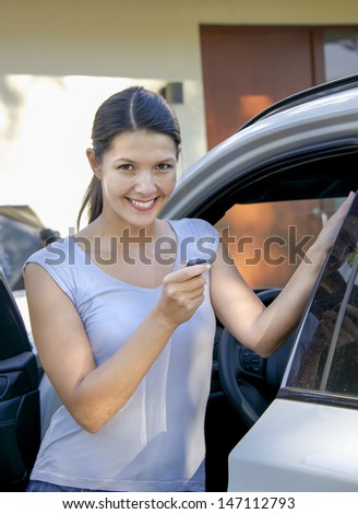 brunette attractive woman shows her new keys for her car