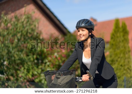 Smiling Active Young Businesswoman Riding a Bicycle with Helmet Going to her Office.