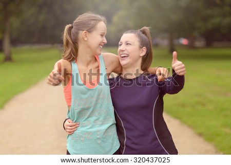 Half Body Shot of Two Happy Healthy Woman at the Park Showing Thumbs Up at the Camera After their Training.