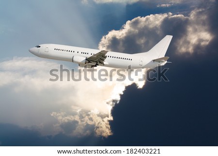 Plane flying with cloud of storm in background