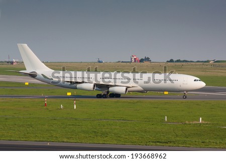 White plane with four engines taxi for take off