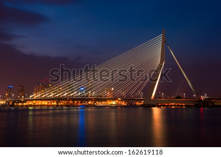 ROTTERDAM, NETHERLANDS - JULY 26: night view of the famous Erasmus Bridge with the cityscape behind on July 26, 2013 in Rotterdam. The 802 meters bridge is from architects Van Berkel & Bos.